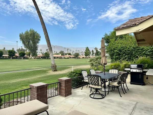 a view of a chairs and table in the patio