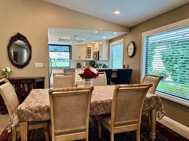a dining room with furniture and window