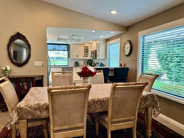 a dining room with furniture and window