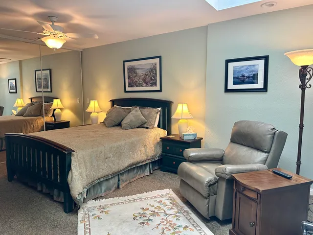 a bedroom with furniture and wooden floor