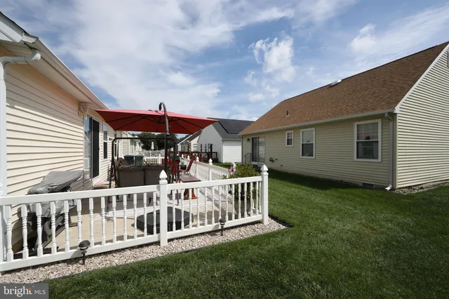 a view of a house with a yard and deck