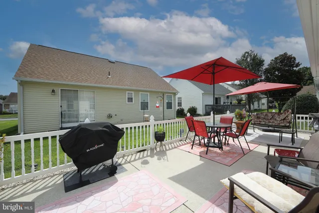a view of house with outdoor sitting area