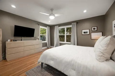 a bedroom with a bed and a flat screen tv