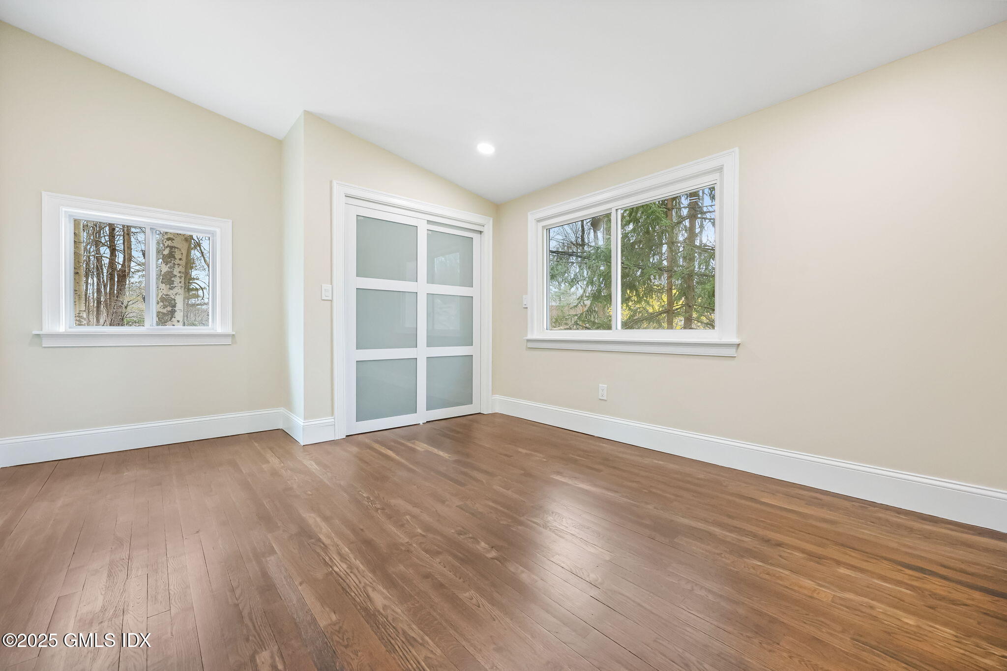 17 Nutmeg Drive Greenwich, CT 06831 - Photo 18 of 35 an empty room with wooden floor and windows