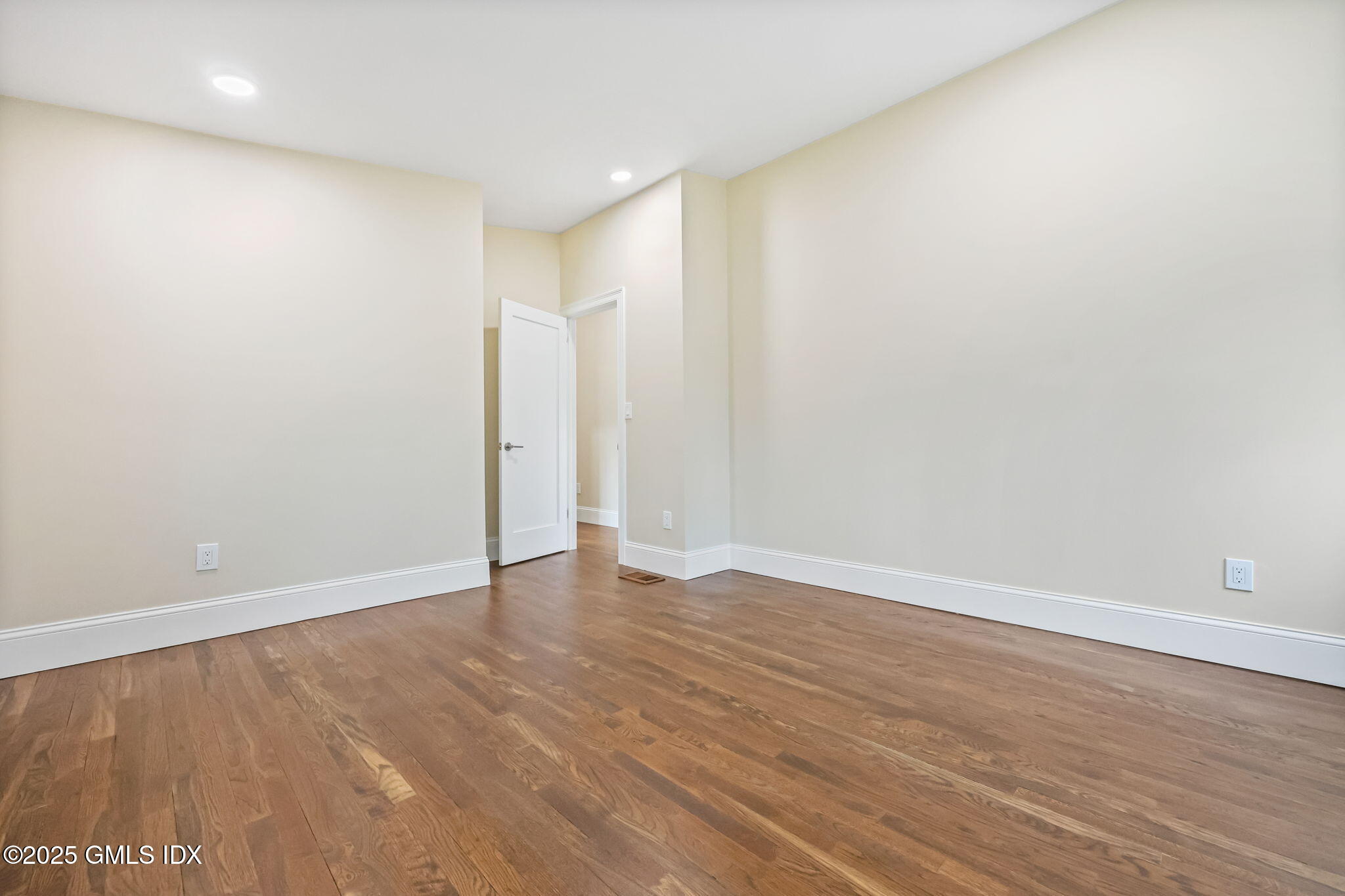 17 Nutmeg Drive Greenwich, CT 06831 - Photo 19 of 35 a view of an empty room with wooden floor