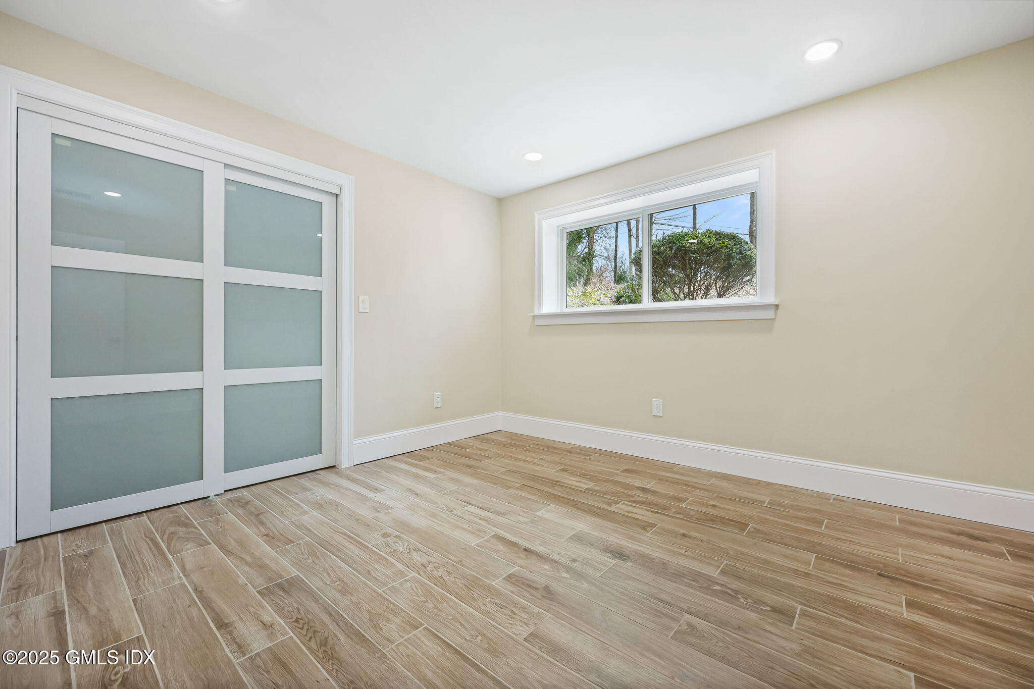17 Nutmeg Drive Greenwich, CT 06831 - Photo 29 of 35 a view of an empty room with wooden floor and a window