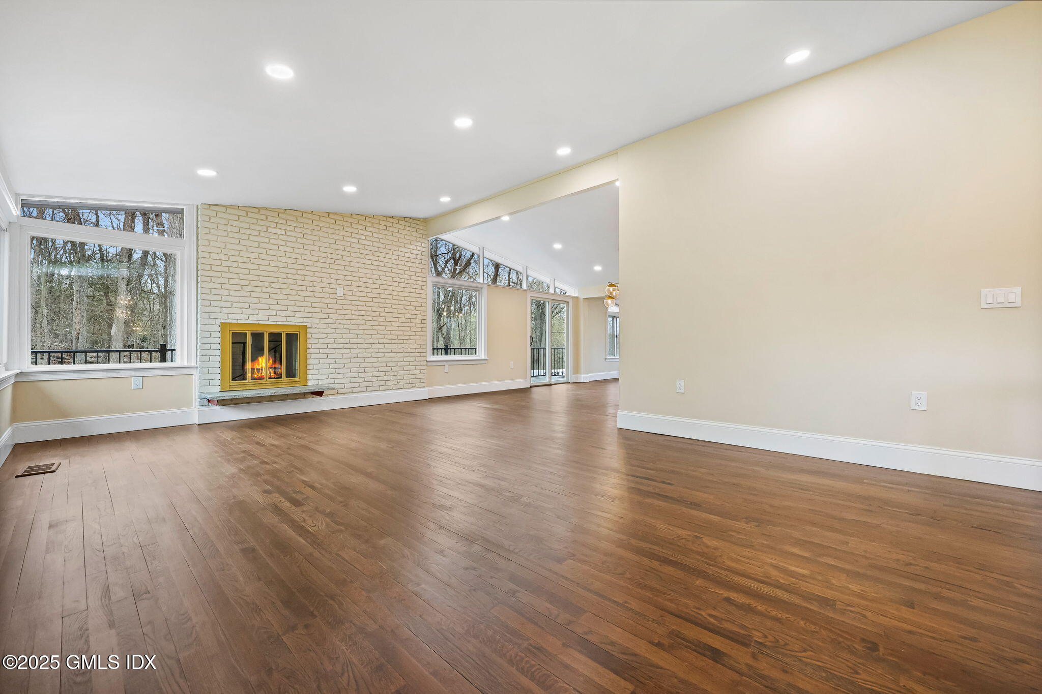 17 Nutmeg Drive Greenwich, CT 06831 - Photo 7 of 35 an empty room with wooden floor and windows
