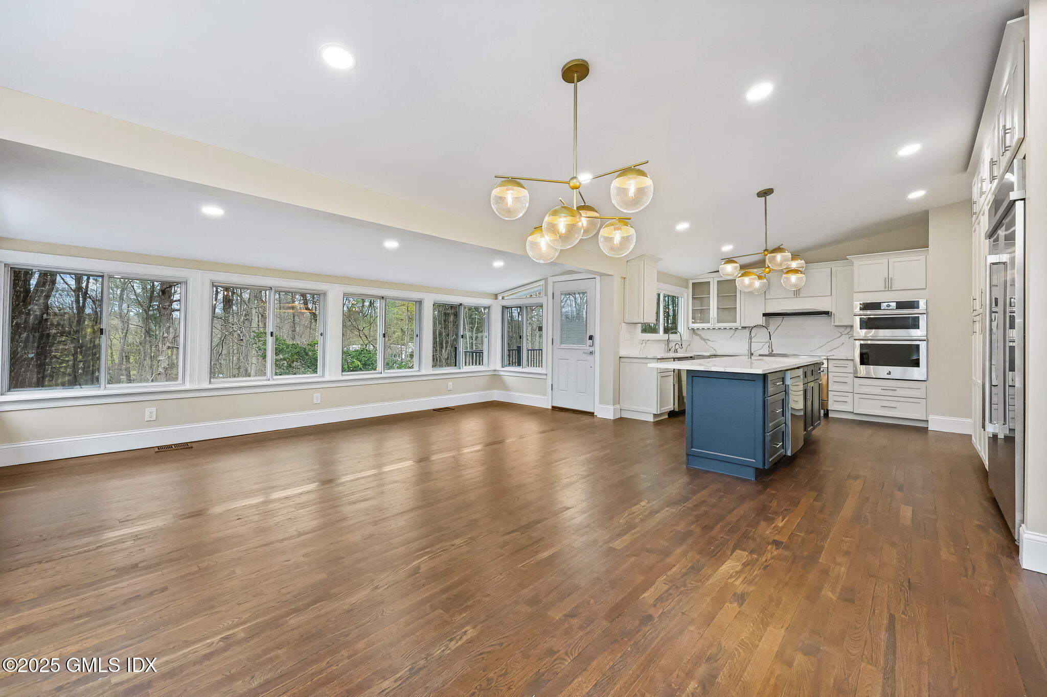 17 Nutmeg Drive Greenwich, CT 06831 - Photo 10 of 35 a large kitchen with lots of counter space and a wooden floor