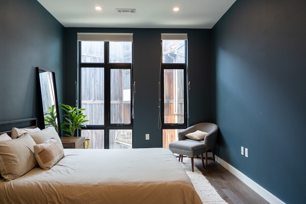 2 Sinclair Road, Unit 202 Boston, MA 02134 - Photo 9 of 23 a bedroom with a bed and a large window