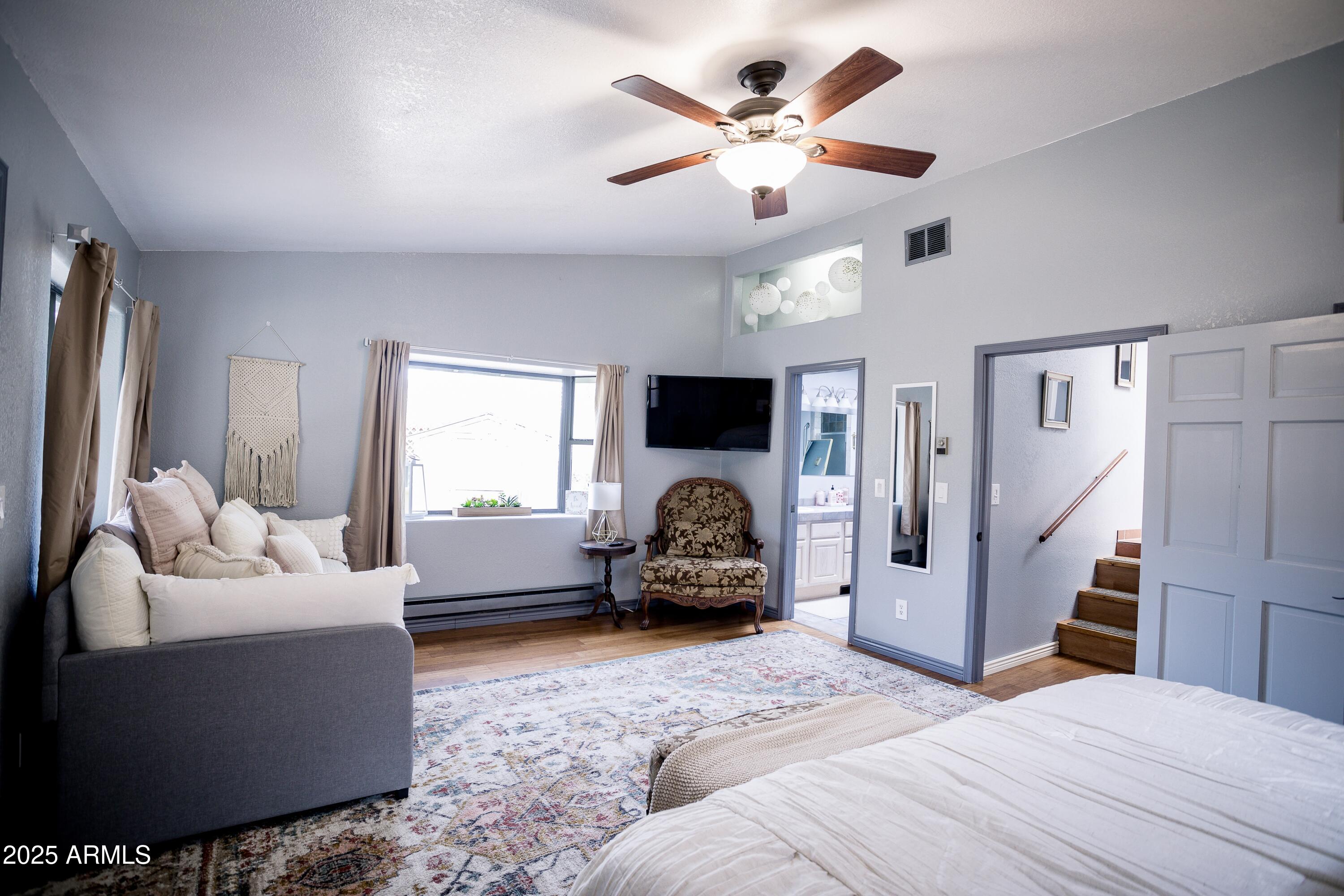 29 East Ramsey Canyon Road Hereford, AZ 85615 - Photo 97 of 119 a bedroom with a bed couch chandelier and a window