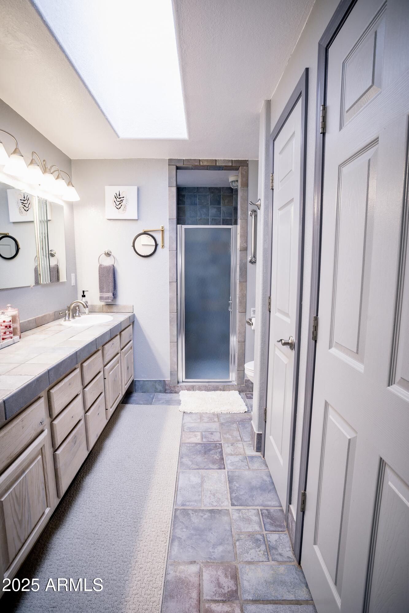 29 East Ramsey Canyon Road Hereford, AZ 85615 - Photo 98 of 119 a bathroom with a double vanity sink a toilet and a mirror