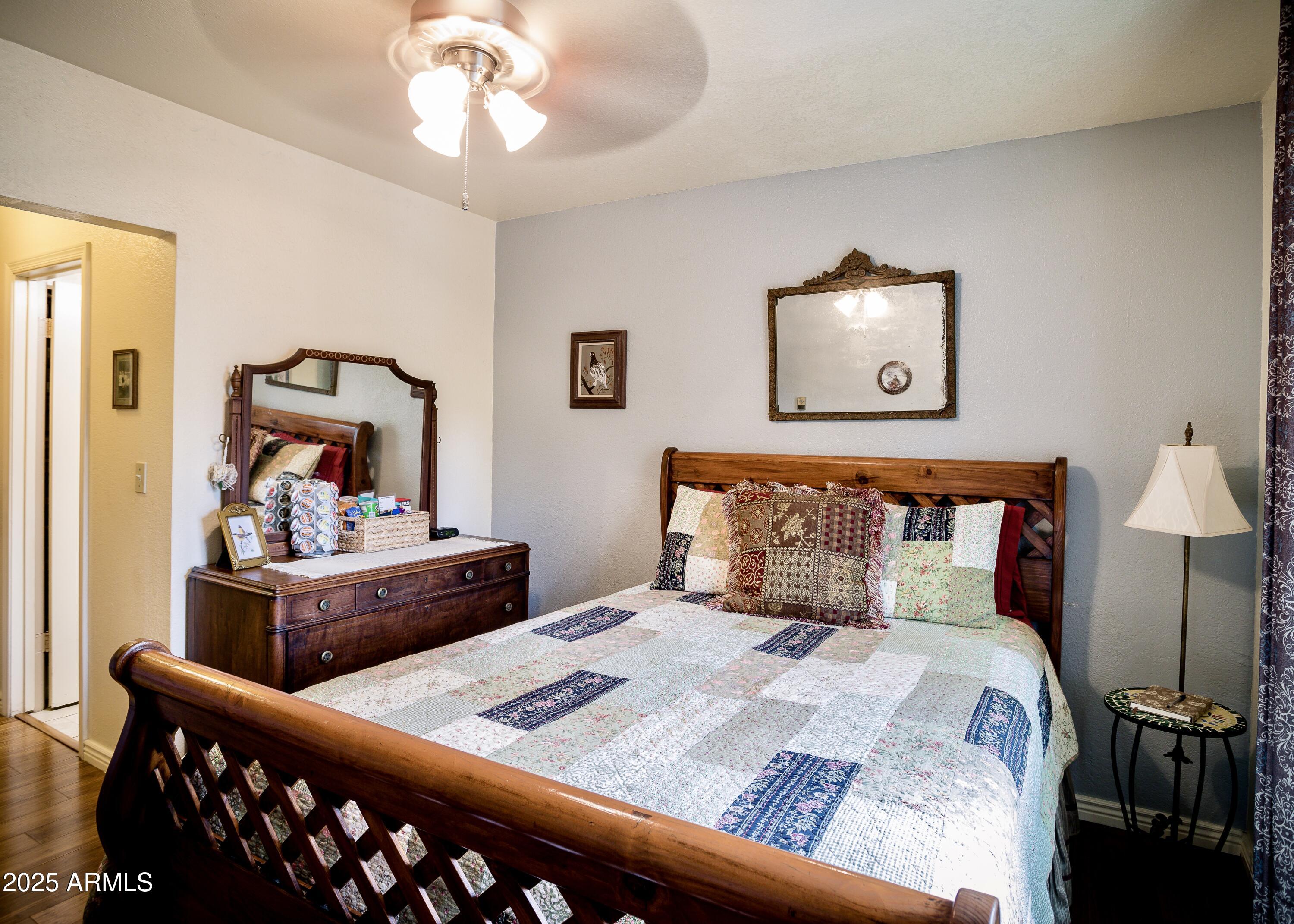 29 East Ramsey Canyon Road Hereford, AZ 85615 - Photo 19 of 119 a bedroom with a bed and wooden floor