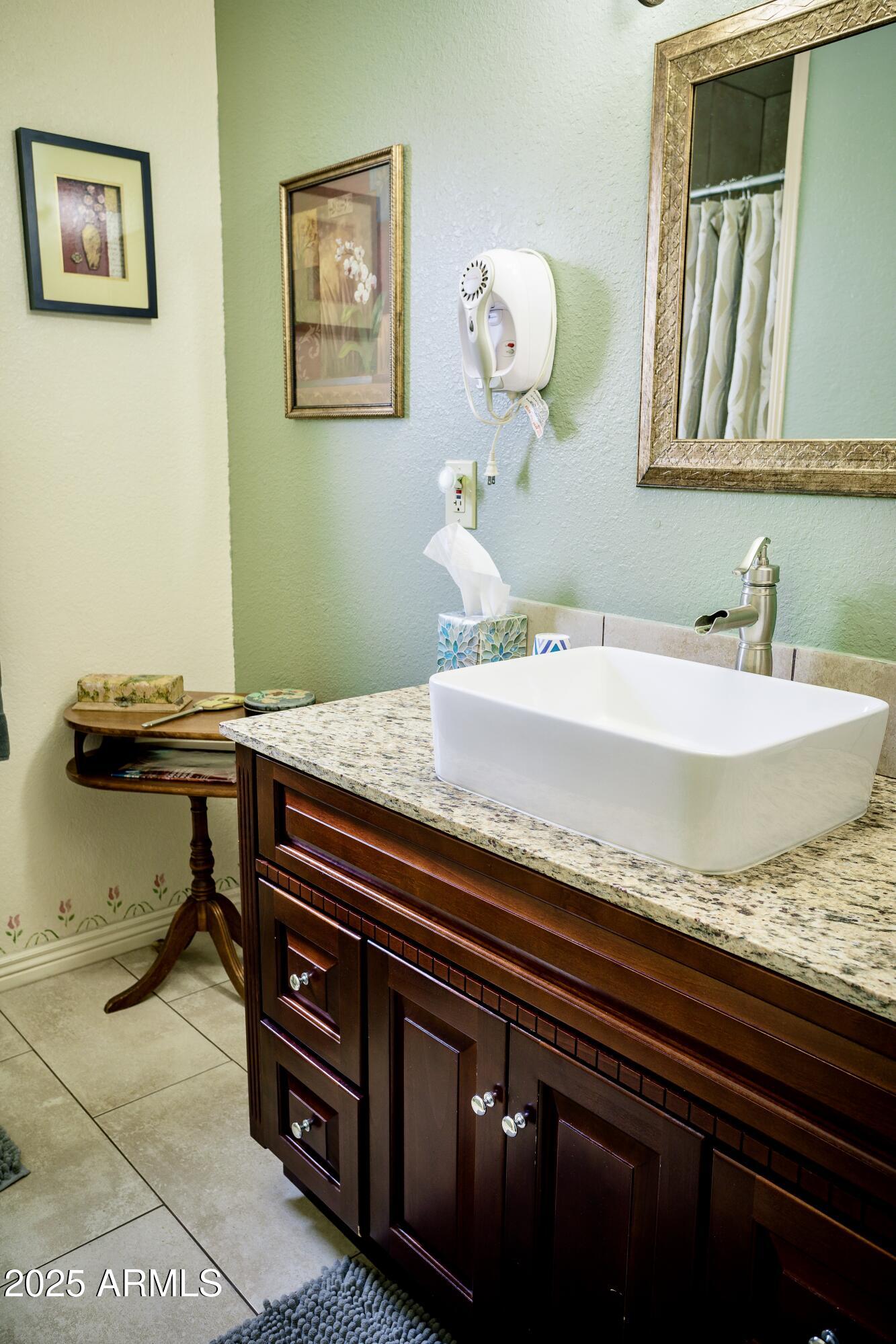 29 East Ramsey Canyon Road Hereford, AZ 85615 - Photo 24 of 119 a bathroom with a granite countertop sink and a mirror