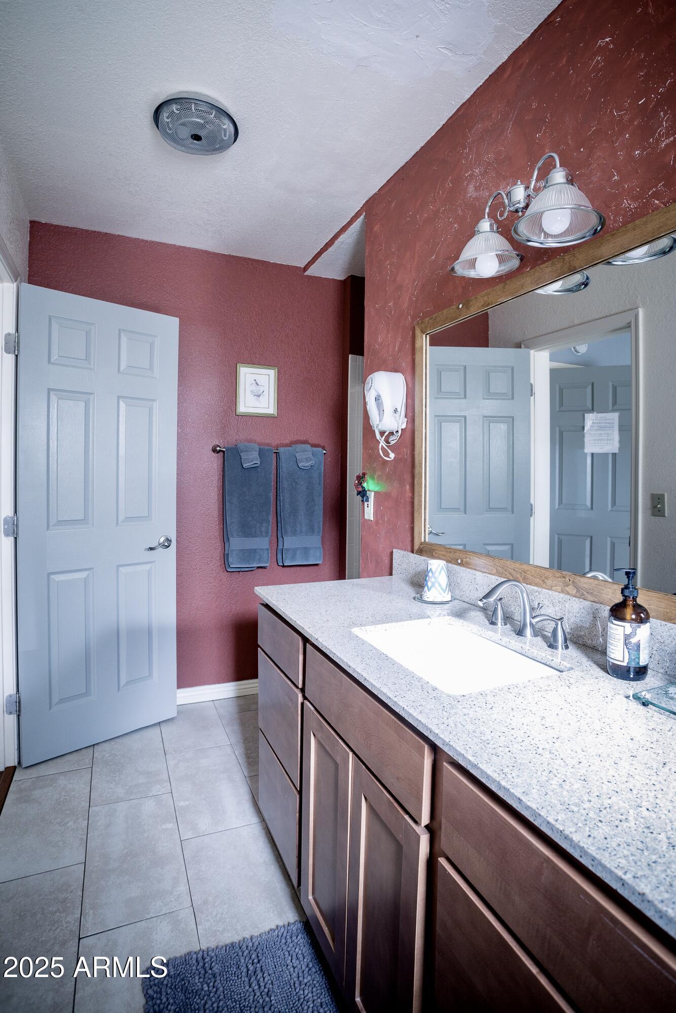 29 East Ramsey Canyon Road Hereford, AZ 85615 - Photo 26 of 119 a bathroom with a sink vanity and a mirror