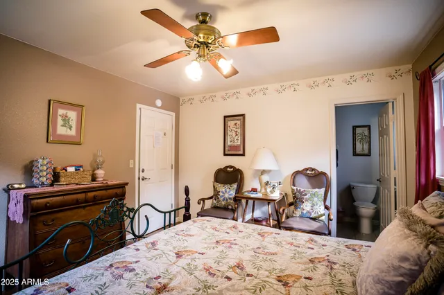 a bedroom with a bed and a painting on the wall