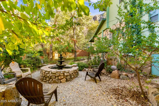 a view of a patio with table and chairs and potted plants