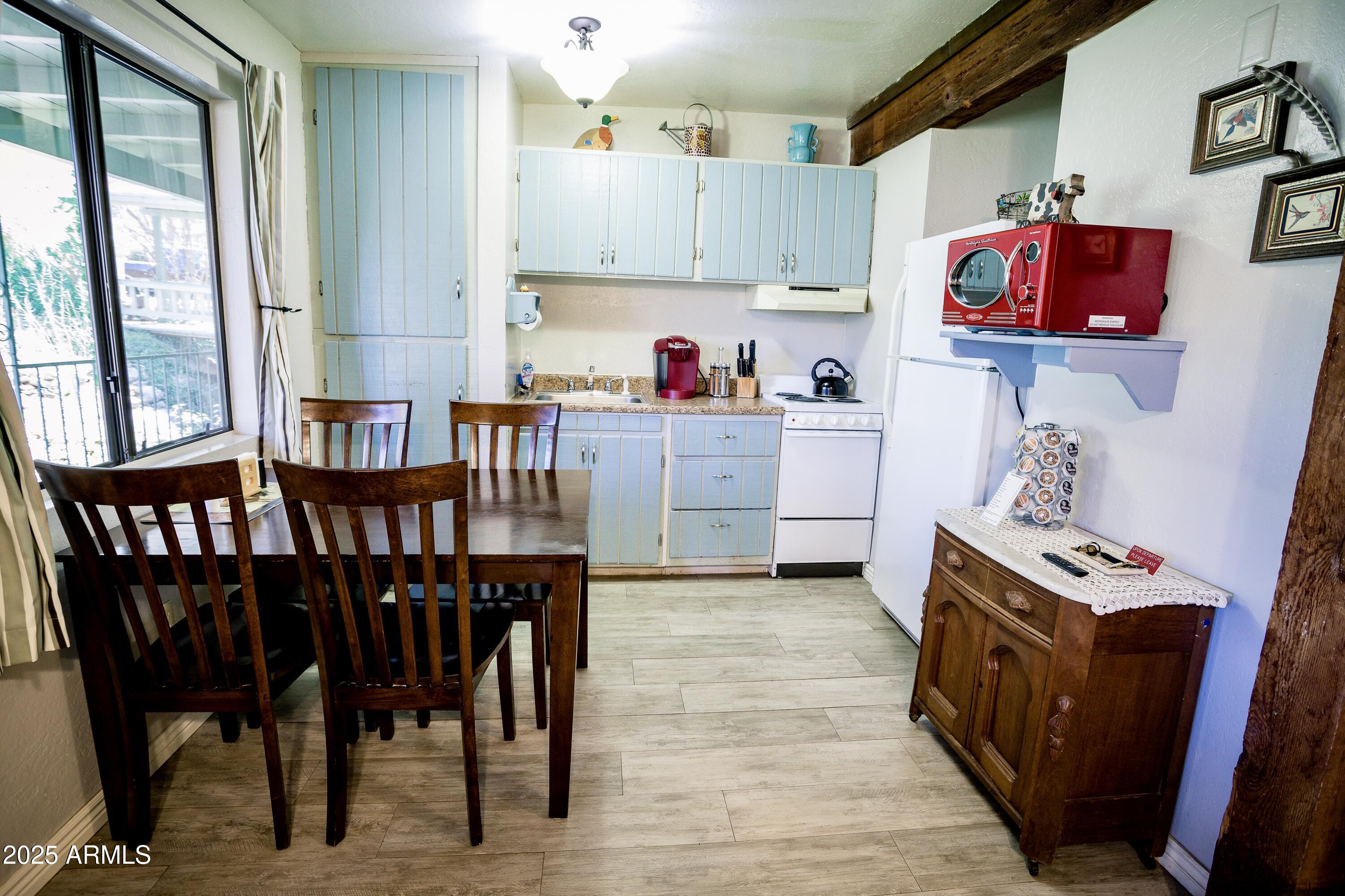 29 East Ramsey Canyon Road Hereford, AZ 85615 - Photo 49 of 119 a kitchen with granite countertop a stove a sink and wooden cabinetry