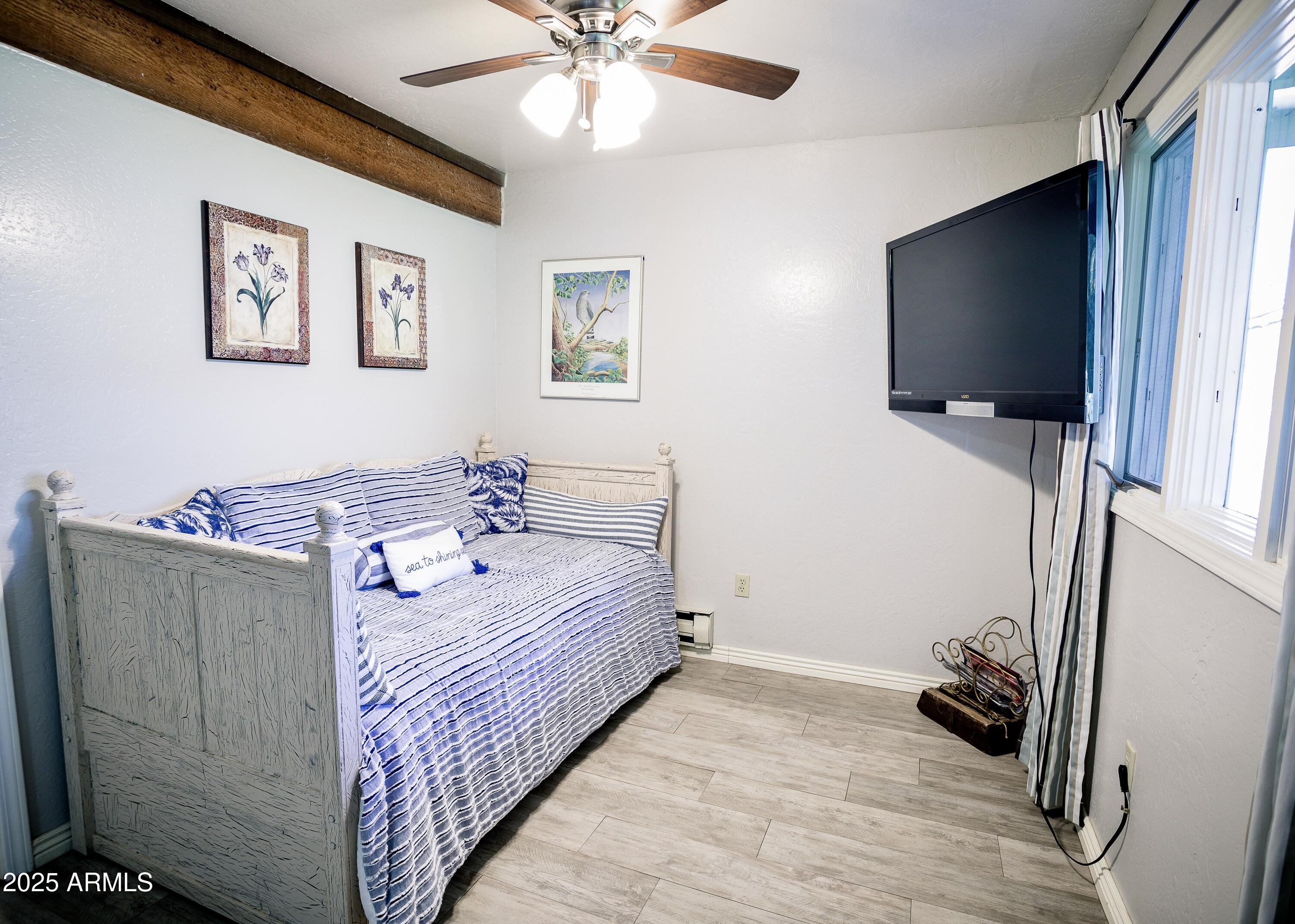 29 East Ramsey Canyon Road Hereford, AZ 85615 - Photo 51 of 119 a bedroom with a bed and a flat screen tv