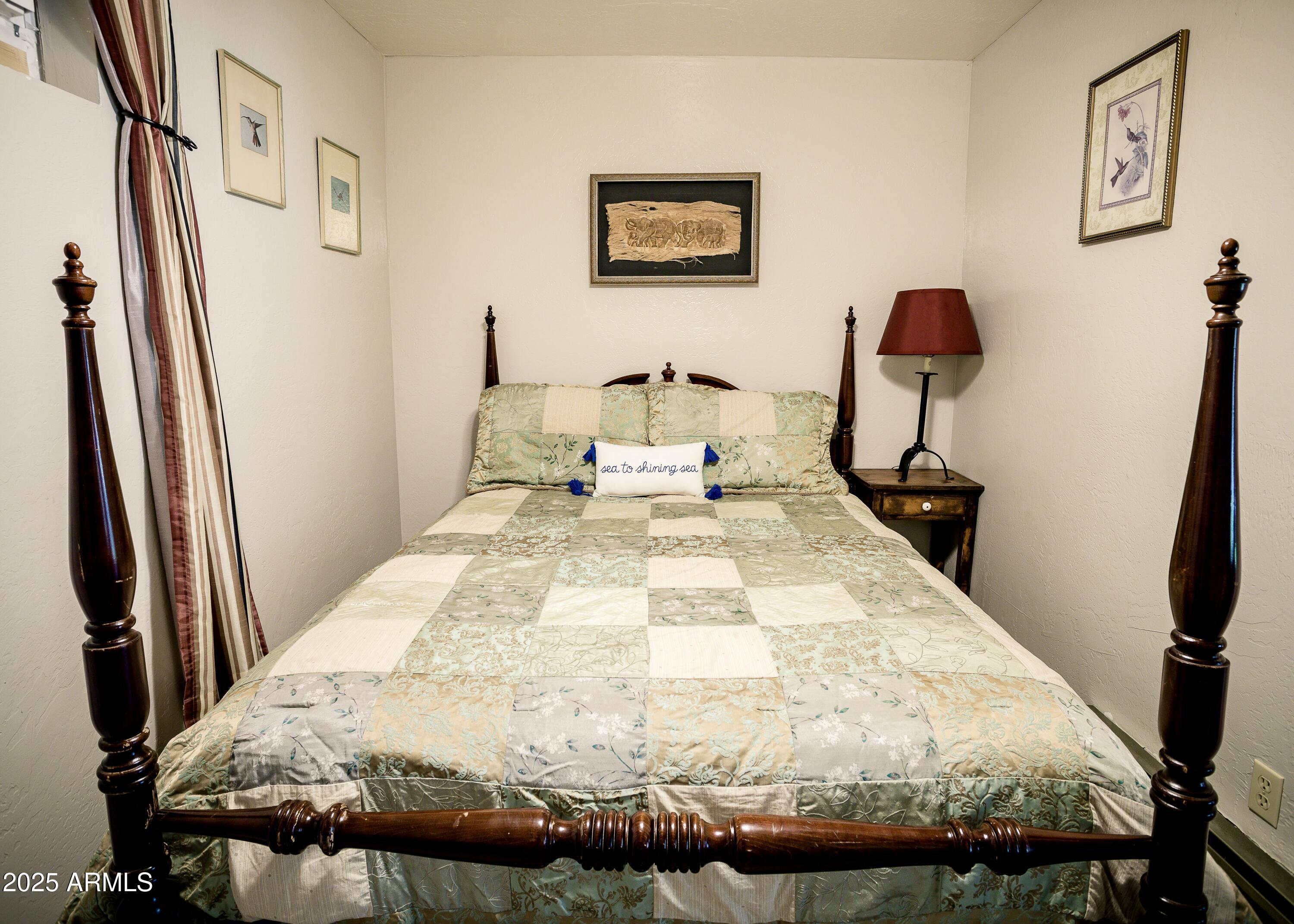 29 East Ramsey Canyon Road Hereford, AZ 85615 - Photo 54 of 119 a bed sitting in a bedroom next to a window