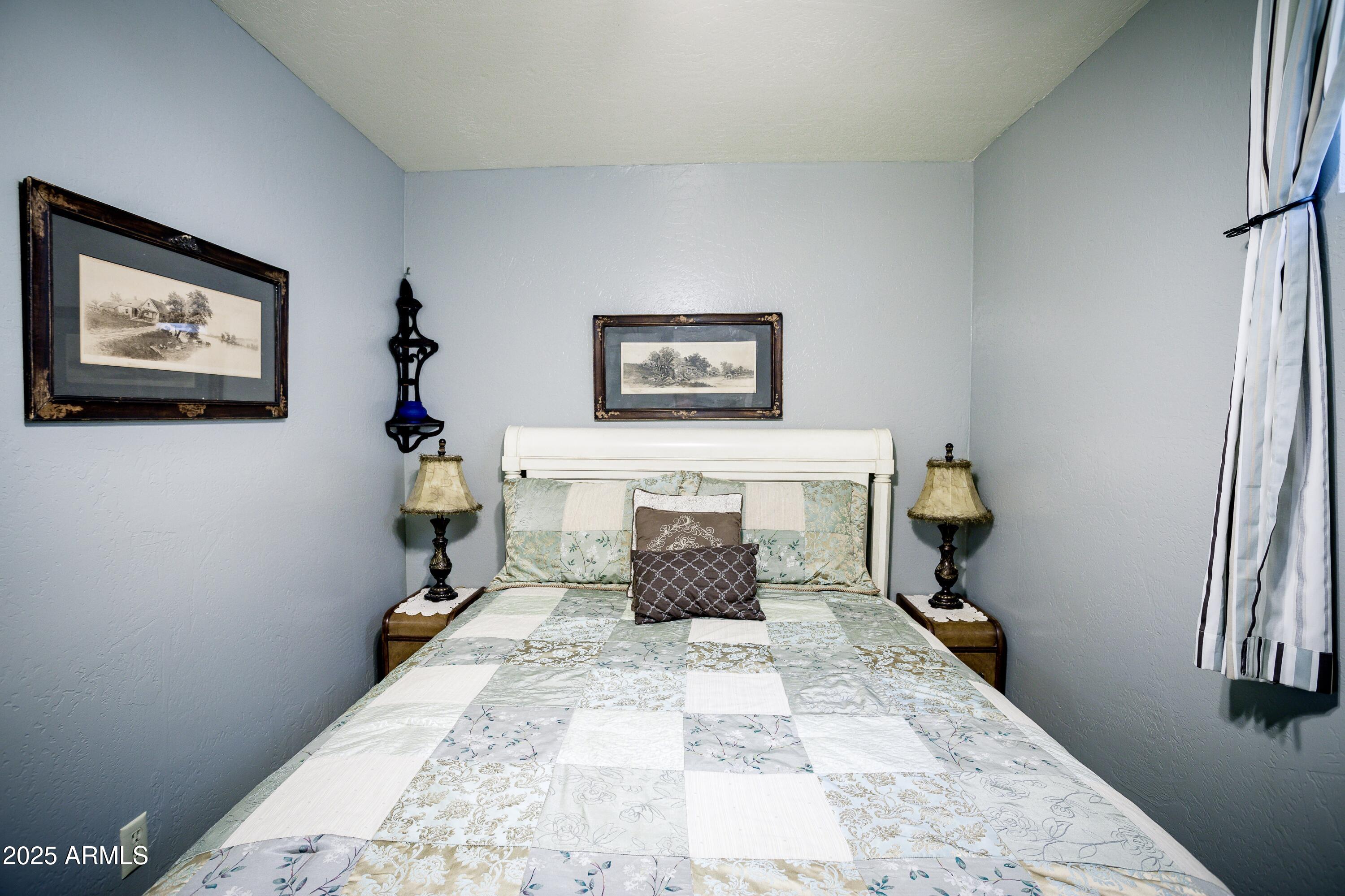 29 East Ramsey Canyon Road Hereford, AZ 85615 - Photo 62 of 119 a bedroom with a bed and a painting on the wall