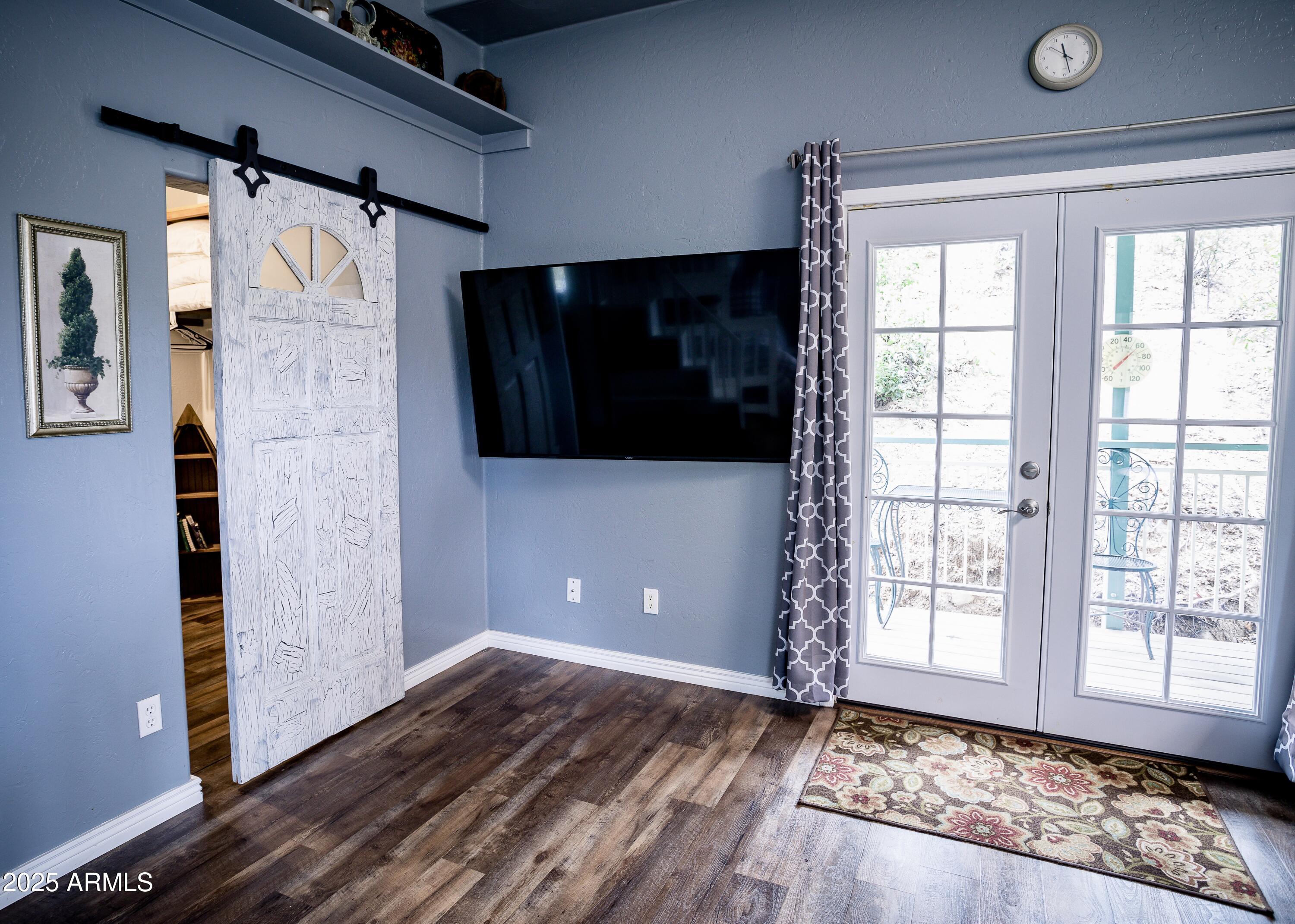 29 East Ramsey Canyon Road Hereford, AZ 85615 - Photo 63 of 119 a view of an empty room with wooden floor and a window