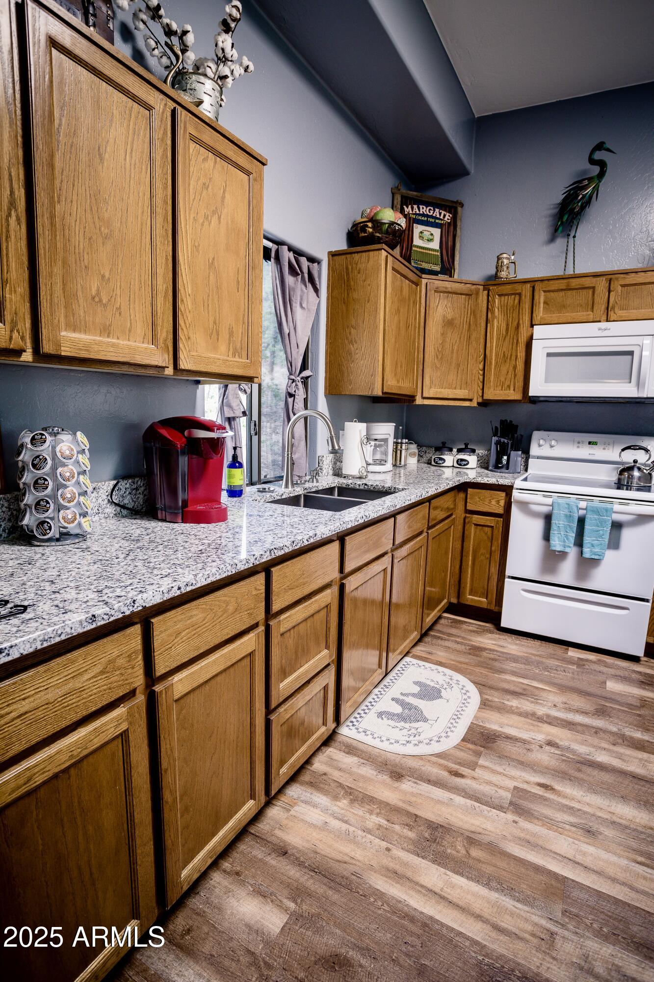 29 East Ramsey Canyon Road Hereford, AZ 85615 - Photo 66 of 119 a kitchen with stainless steel appliances granite countertop a sink and cabinets