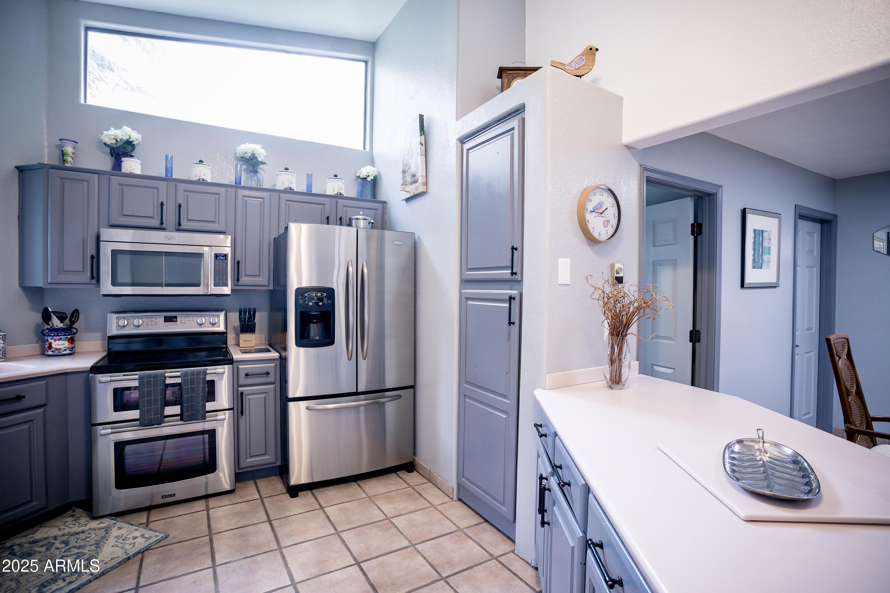 29 East Ramsey Canyon Road Hereford, AZ 85615 - Photo 86 of 119 a kitchen with stainless steel appliances a refrigerator sink and cabinets