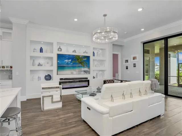 a living room with furniture and a chandelier