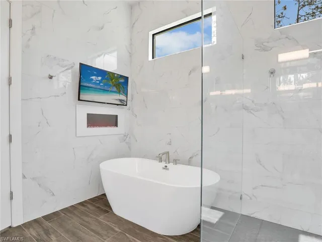 a bathroom with a bathtub and shower