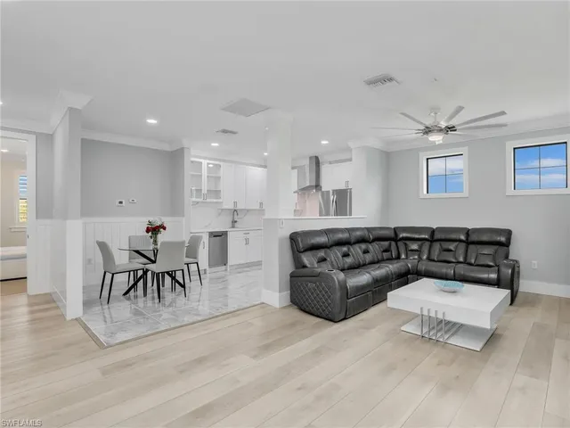 a large kitchen with a table and chairs