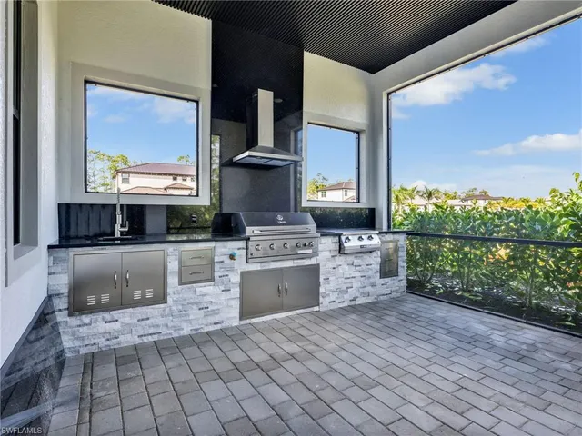 a kitchen with stainless steel appliances granite countertop a stove and a wooden cabinets