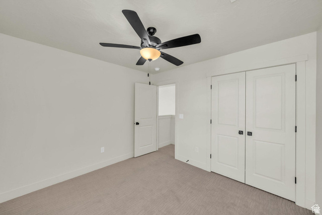 560 Aqua Cove St. George, UT 84790 - Photo 16 of 27 Unfurnished bedroom with carpet floors, a ceiling fan, and a closet