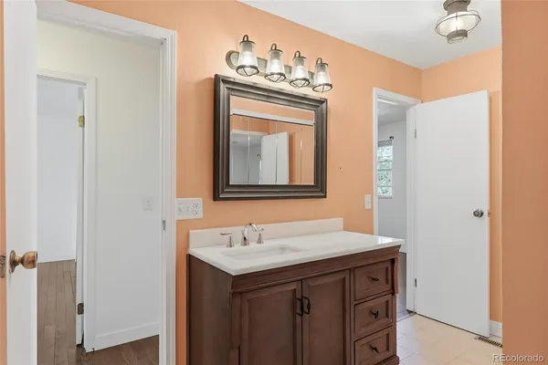 a bathroom with a sink vanity and a mirror