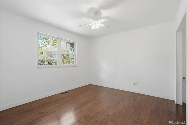 wooden floor in an empty room with a window