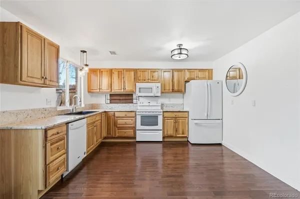 a kitchen with appliances cabinets and a sink