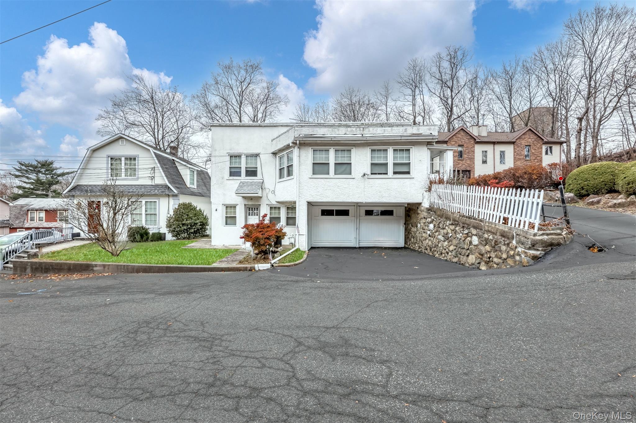 4 Cedar Lane Suffern, NY 10901 - Photo 1 of 16 a front view of a house with a garden and trees