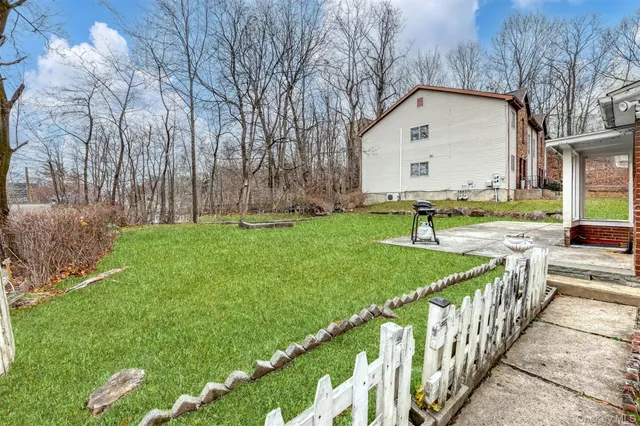 a view of a house with backyard and sitting area