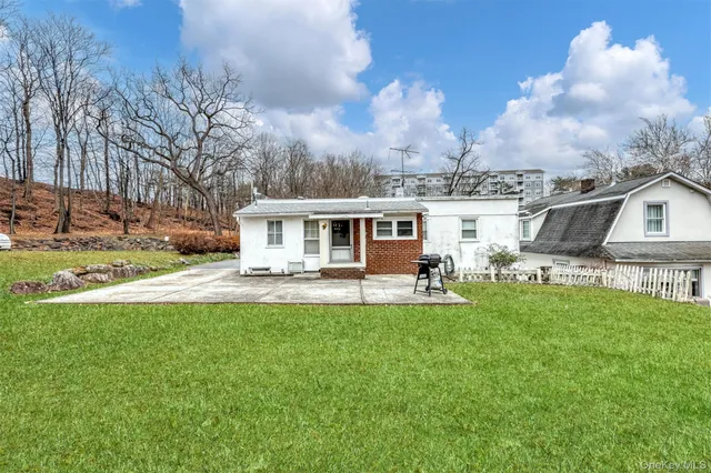 a front view of a house with yard patio and fire pit