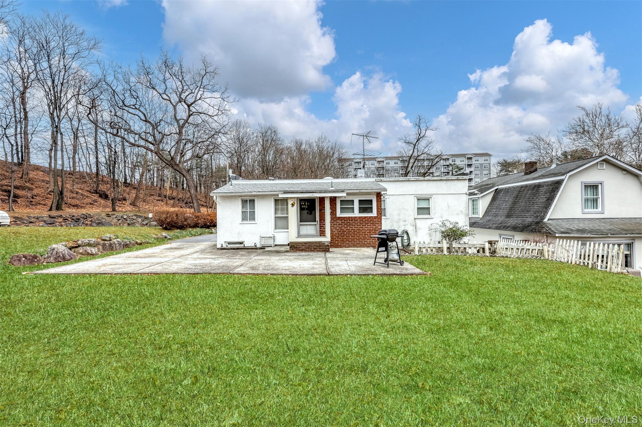 4 Cedar Lane Suffern, NY 10901 - Photo 4 of 16 a front view of a house with yard patio and fire pit