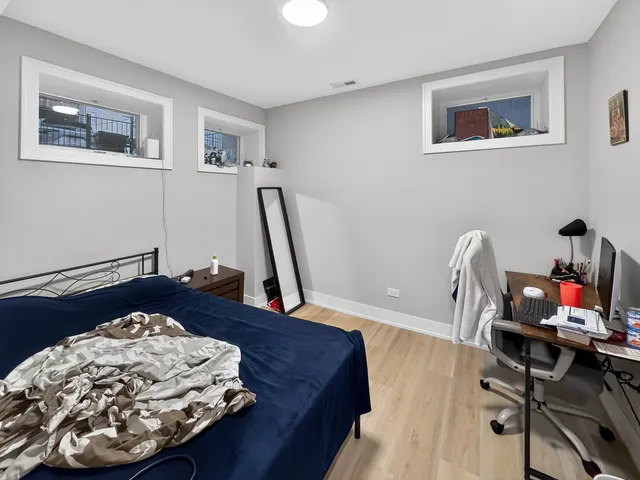 a bed room with a bed and a chair