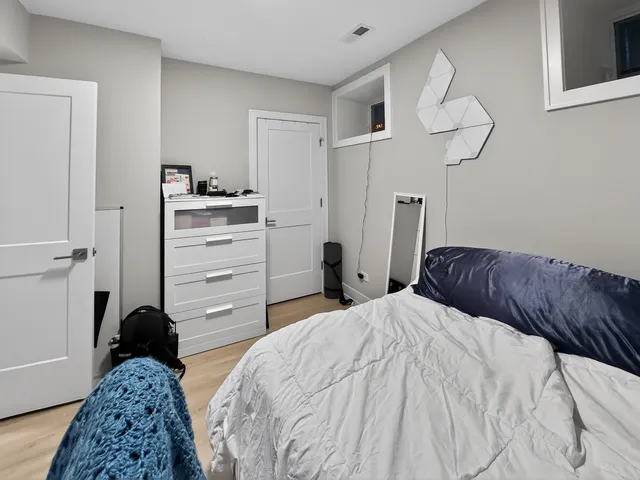 a bedroom with a bed and cabinets