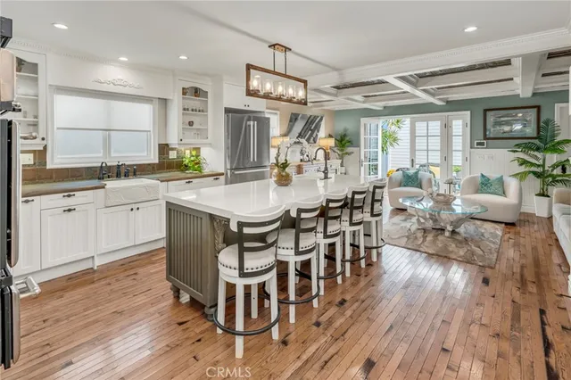 a living room with lots of furniture and kitchen view