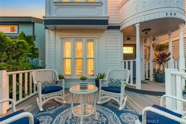 a balcony with furniture and a potted plant