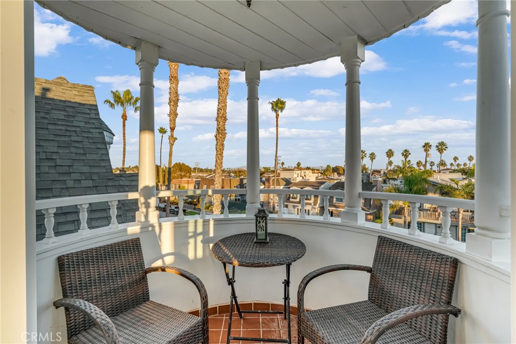 309 21st Street Huntington Beach, CA 92648 - Photo 32 of 38 a dining room with furniture a chandelier and wooden floor