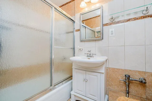 a bathroom with a sink a mirror and a shower