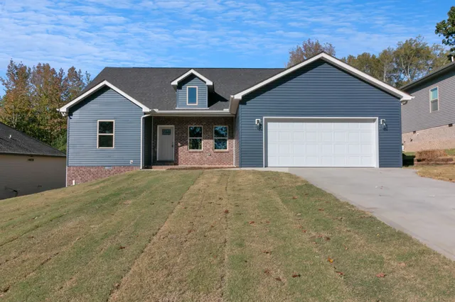 a front view of a house with a yard and garage