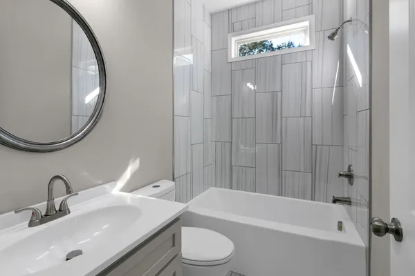 a bathroom with a sink a toilet and a mirror