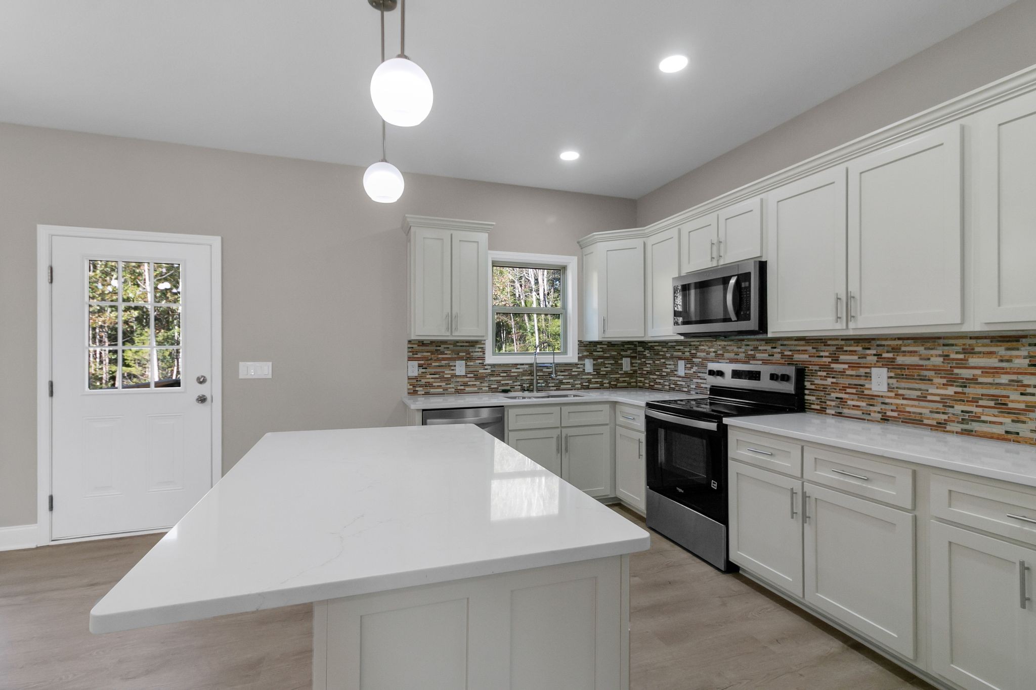 74 Mockingbird Lane Paris, TN 38242 - Photo 6 of 21 a kitchen with sink a microwave and cabinets