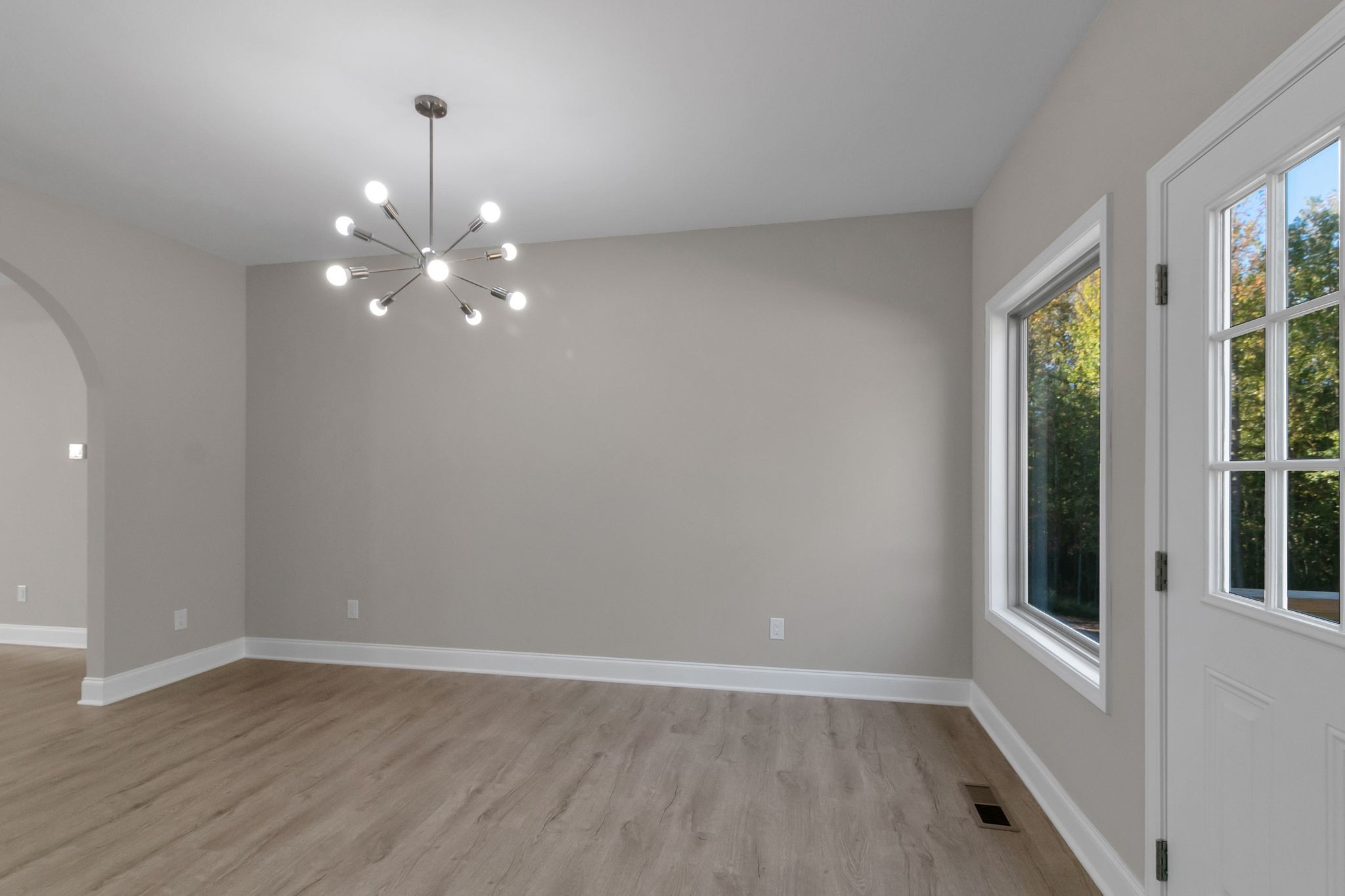 74 Mockingbird Lane Paris, TN 38242 - Photo 9 of 21 an empty room with wooden floor and windows