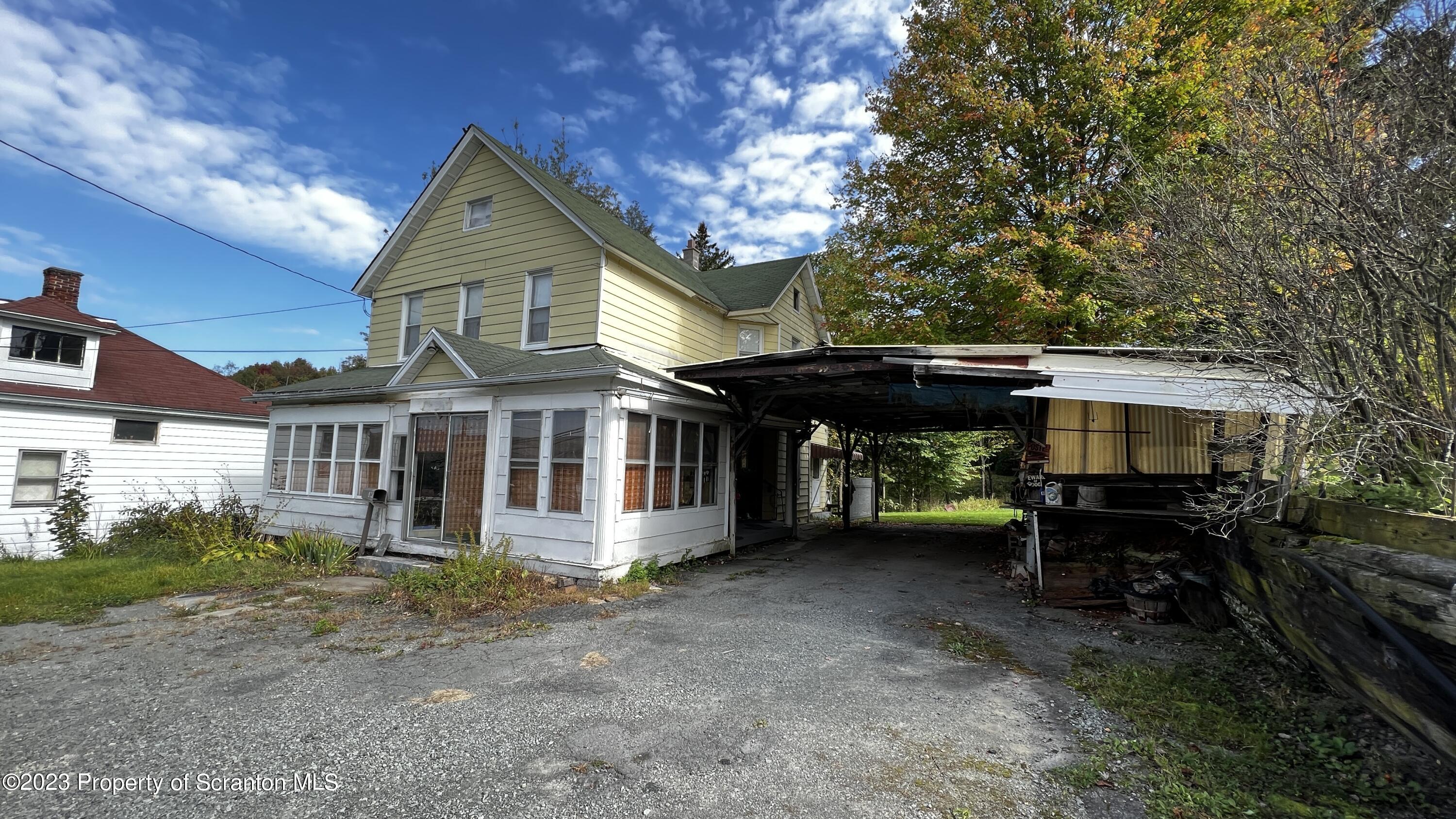 a view of a house with a yard and sitting area